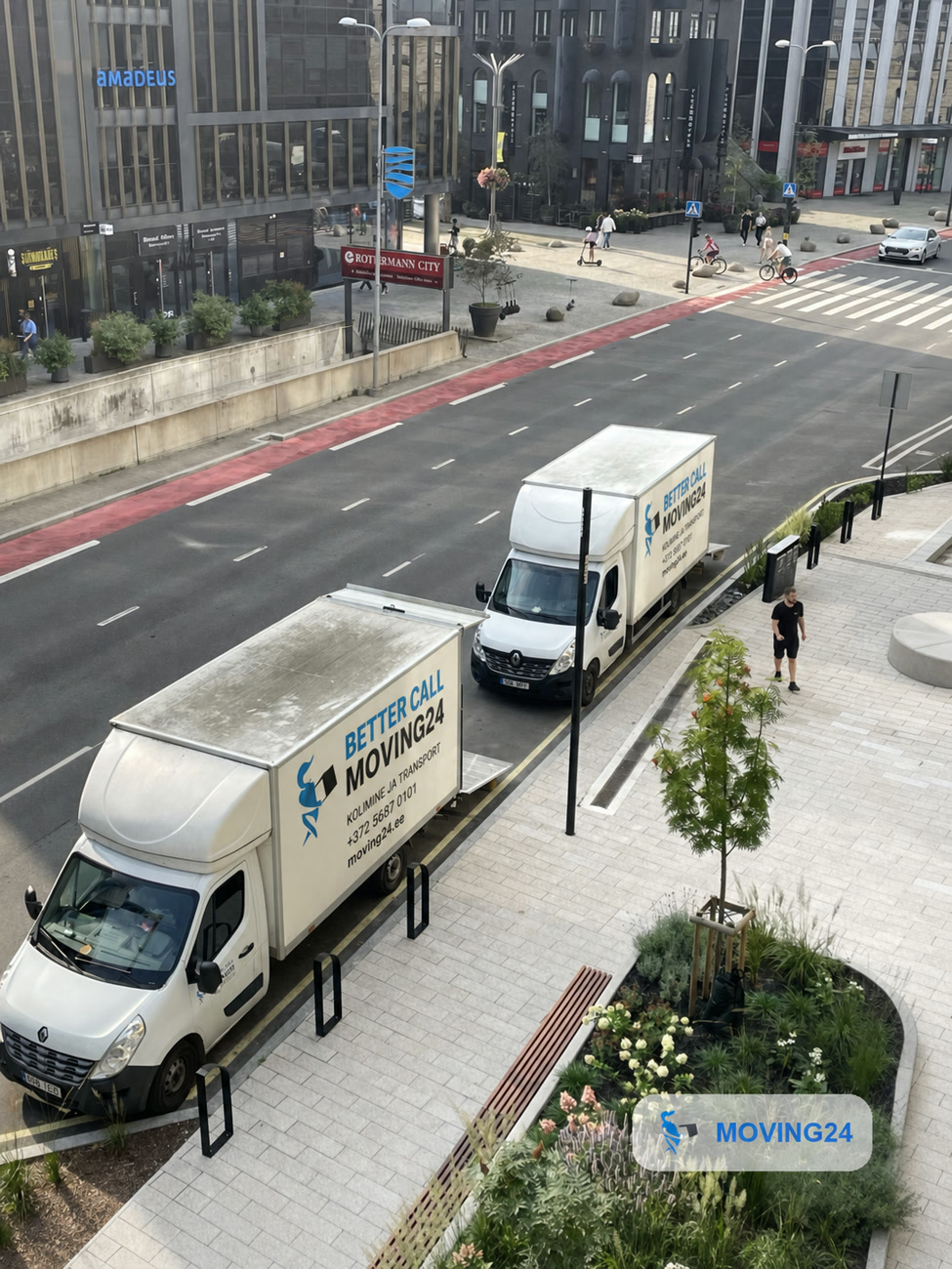 Moving24 vans against the city skyline
